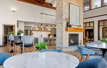 Resident lounge with kitchen, dining space and fireplace